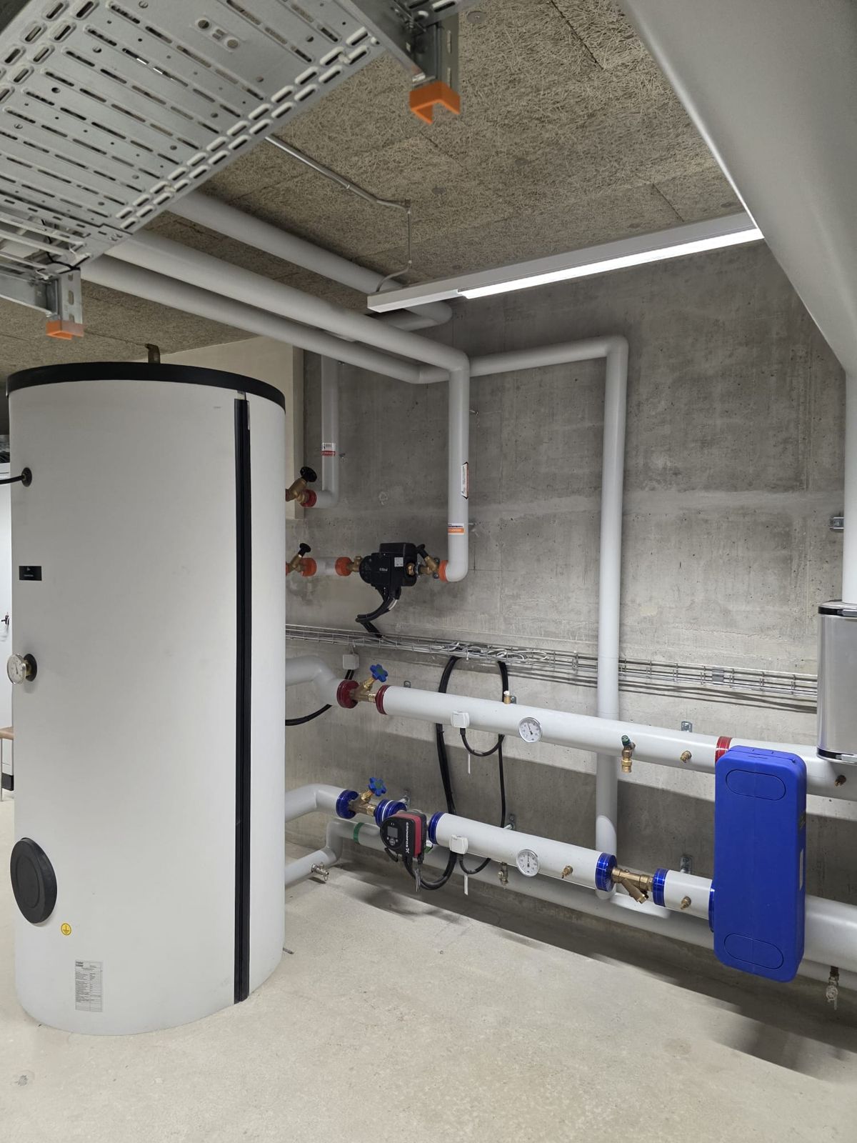 Chaufferie avec accumulateur d’eau chaude, pompes de circulation et distribution isolée